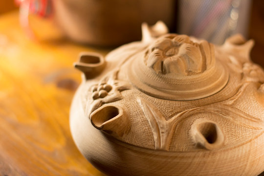 Close up on a wooden grole, a traditional italian cup handcrafted in wood and decorated with small lids.