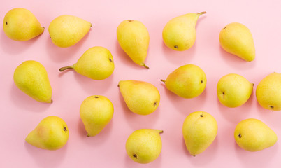 Yellow lots of pears on a pink background.