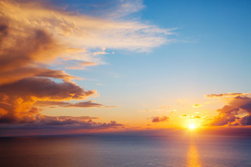 Unusual vivid clouds illuminated by the beams of the sun.