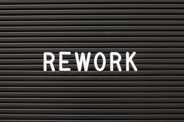 Black color felt letter board with white alphabet in word rework background