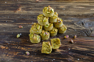 Set of financier cakes with pistachios on wooden backgraunde