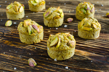 Set of financier cakes with pistachios on wooden backgraunde