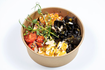 Hawaiian salmon fish poke bowl with rice, radish,cucumber, tomato, sesame seeds and seaweeds. Buddha bowl. Diet food