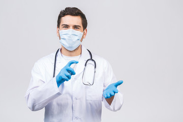 Doctor man in gown face mask gloves isolated on white background. Epidemic pandemic coronavirus...