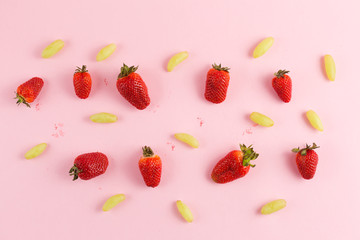 strawberries and grapes on a pink background