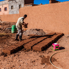 Crafts man making clay building blocks in Ait ben Haddou, Morocco
