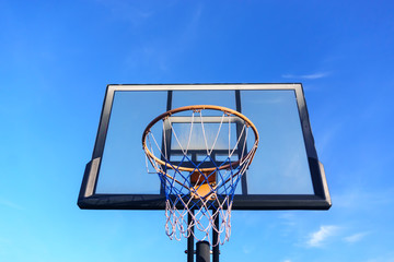 Basketball shield with a basket on the sky background