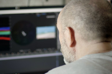 Senior Professional Photographer Or Videographer Works in Photo Editing App Software on His Personal Computer. Video Editor Working At Home 