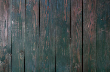Green paint on an old wooden background. Fence.