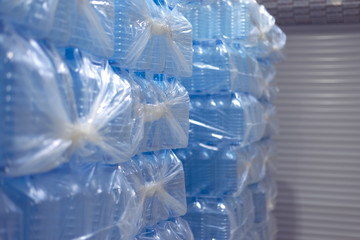 Bottling plant - Water bottling line for processing and bottling pure spring water into blue bottles. Selective focus.