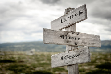 listen learn grow text engraved on old wooden signpost outdoors in nature. Quotes, words and...