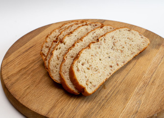 several pieces of chopped bran bread lie on a textured board