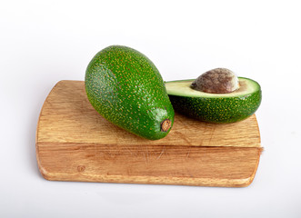 half avocado with a branch of fresh red Basil with a knife, isolated on a white background