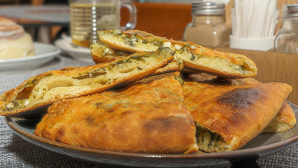 Two Georgian pies. One with cheese, the other with spinach. Traditional Georgian dish khachapuri.