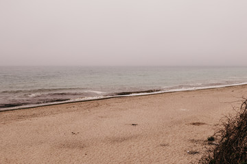 Sea shore in the fog during the day