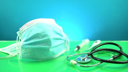 Coronavirus or Covid-19 Medical mask with Stethoscope,Electronic thermometer and syringe on table - Powered by Adobe