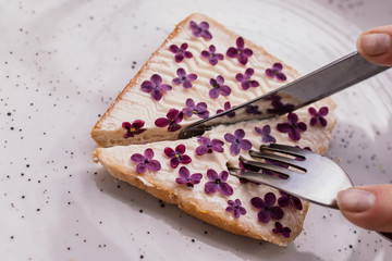 Cut sandwich with flowers and a knife with a fork