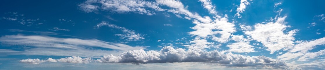 Clouds on blue sky background, ultra wide panorama