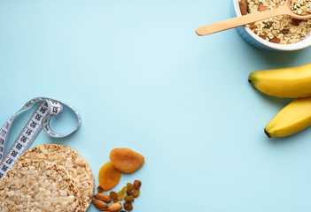 Useful breakfast, proper nutrition, oatmeal, dried fruits, breads, fruits, a centimeter on a light background. Diet. A place for text.