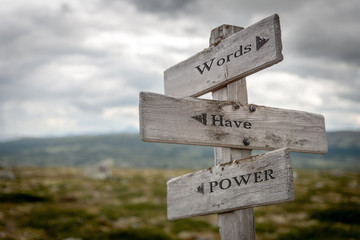words have power text engraved on old wooden signpost outdoors in nature. Quotes, words and...