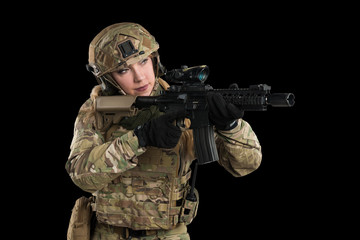 Female soldier in tactical black uniform with rifle. Shot in studio. Isolated with clipping path on black background