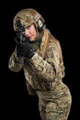 Female soldier in tactical black uniform with rifle. Shot in studio. Isolated with clipping path on black background