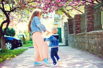 Playful child and young mother enjoy springtime. Spring lifestyle.