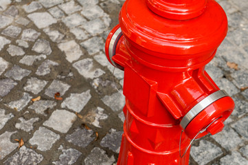 Bright red isolated fire hydrant in old city center