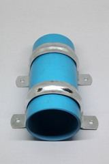 PVC sewage cleanout and steel clamp for drainage system of building.