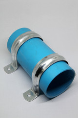 PVC sewage cleanout and steel clamp for drainage system of building.