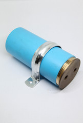 PVC sewage cleanout with brass lid and steel clamp for drainage system of building.