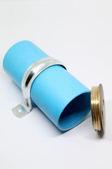 PVC sewage cleanout with brass lid and steel clamp for drainage system of building.