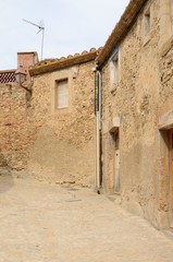 Fototapeta na wymiar Lonely cobbled alley in Girona village