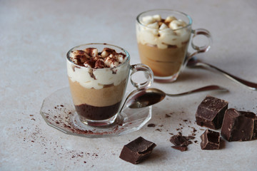 two coffee cream glass cups with cocoa powder