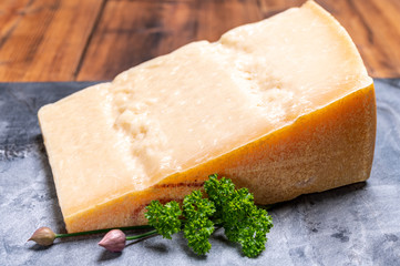 Big wedge of parmigiano-reggiano parmesan hard Italian cheese made from cow milk or Grana Padano