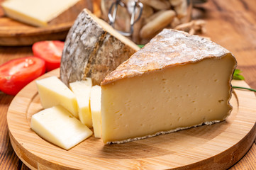 Cheese tomme de montagne or tomme de savoie made from cow milk in French Alps.