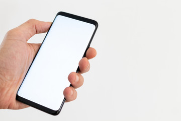 Smartphone blank with hand and fingers tap on screen with white background. Smartphone mockup with space for text and screen