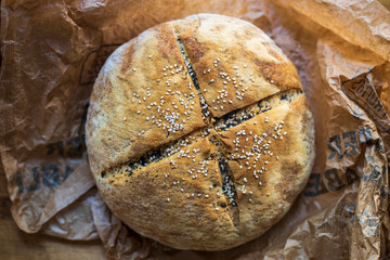 homemade bread with sesame seeds on the table