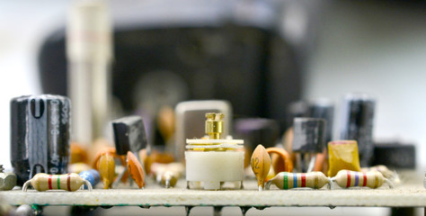 Dusty and dirty vintage electronics background with resisters, capacitors,diodes and other components