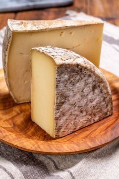 Cheese tomme de montagne or tomme de savoie made from cow milk in French Alps.