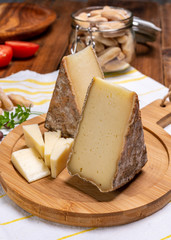 Cheese tomme de montagne or tomme de savoie made from cow milk in French Alps.