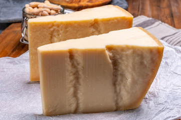 Big wedges of parmigiano-reggiano parmesan hard Italian cheese made from cow milk or Grana Padano