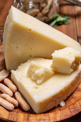 Pieces of matured pecorino romano italian cheese made from sheep milk in Lazio, Sardinia or Tuscany