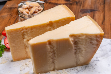 Big wedges of parmigiano-reggiano parmesan hard Italian cheese made from cow milk or Grana Padano