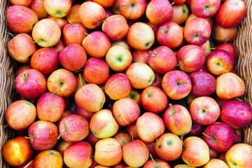 Red apples on the market counter. Apples in wooden boxes on the grocery shelf. Close up.