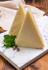 Pieces of matured pecorino romano italian cheese made from sheep milk in Lazio, Sardinia or Tuscany