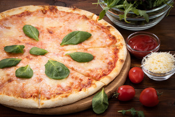 pizza with cheese sauce and spinach on wooden background