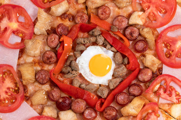 pizza with egg, ham, meat and tomatoes on wooden background. Top view