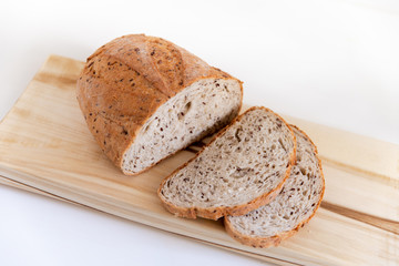 Sliced grain bread on a cutting Board.