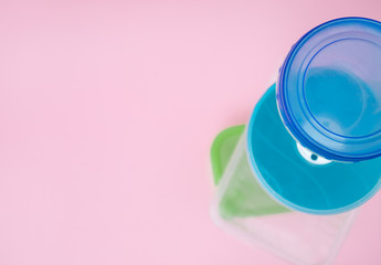 different plastic food containers on a colored background. top view on food boxes. Place for text